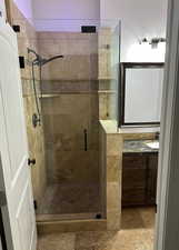 One of many bathrooms with vanity and a stall shower
