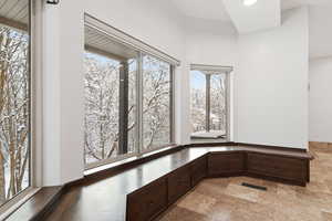 View of basement living area with a plenty of natural light, light stone finish flooring, and recessed lighting
