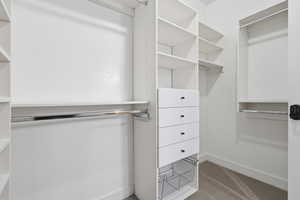 Walk in closet featuring carpet flooring