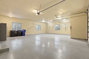 Garage featuring freestanding refrigerator