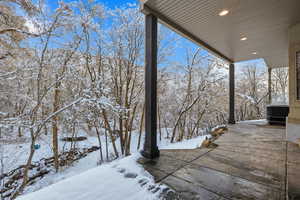 Yard covered in snow with a patio area