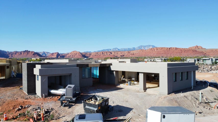 Rear view of house featuring a mountain view, stucco siding, and a patio