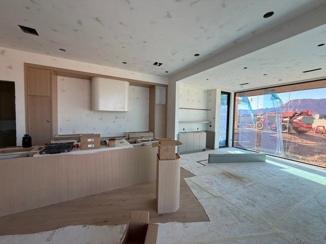Kitchen featuring light wood-style floors, light wood finish cabinetry, and floor to ceiling windows
