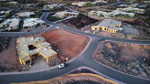 Aerial view of property and surrounding area featuring nearby suburban area