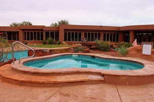 Swimming pool with a patio and a sunroom