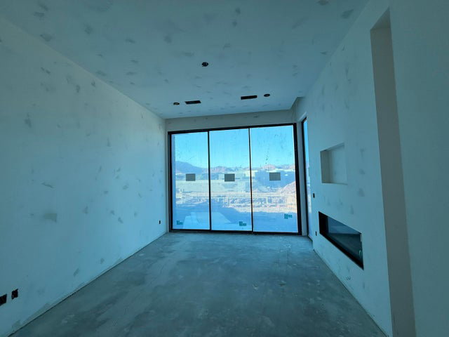 Unfurnished living room featuring concrete floors