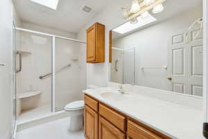 Bathroom featuring vanity, a shower, and light tile patterned flooring.