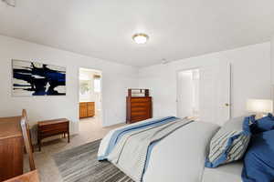 Bedroom with carpet floors and ensuite bathroom