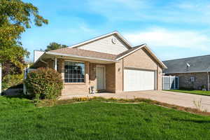 Ranch-style home featuring driveway, a shingled roof, brick siding, and an attached garage