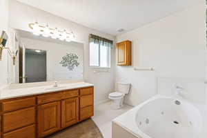 Full bath with a tub with jets and vanity