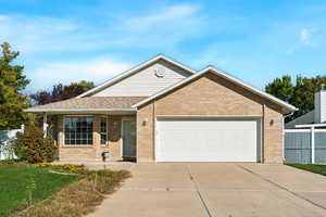 Ranch-style house featuring brick siding, a porch, concrete driveway, a garage, and roof with shingles
