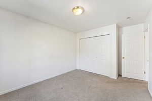 Unfurnished bedroom featuring carpet floors and a closet