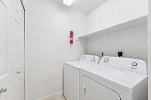 Laundry room with washer, dryer and linen/ storage closet.