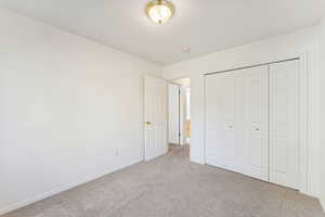 Unfurnished bedroom with carpet floors and a closet