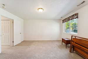Primary bedroom with light carpet and connected bathroom