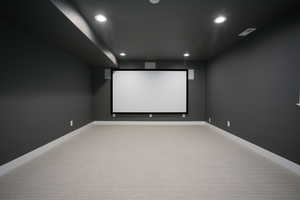 Home theater with carpet floors and recessed lighting