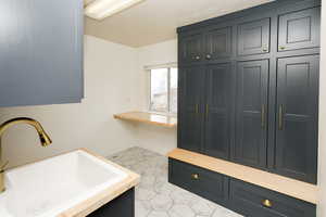 Washroom with a sink and baseboards