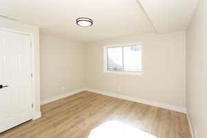 Spare room featuring light wood-style flooring