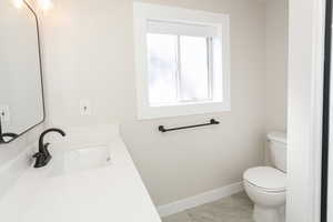 Half bath with vanity and light tile patterned floors