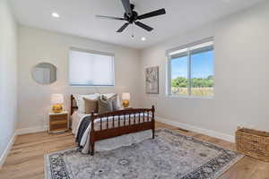 Bedroom with recessed lighting, light wood-type flooring, and a ceiling fan
