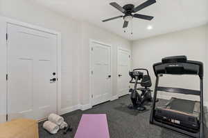 Exercise area with a ceiling fan and recessed lighting