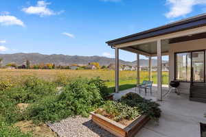 View of yard featuring a mountain view, a residential view, and covered porch