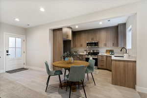 Kitchen with stainless steel appliances, light wood-type flooring, modern cabinets, recessed lighting, and healthy amount of natural light