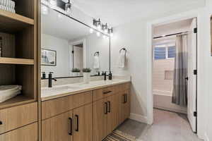 Full bath with shower / bath combo and double vanity