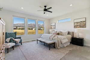 Bedroom featuring light colored carpet, recessed lighting, a ceiling fan, and a mountain view