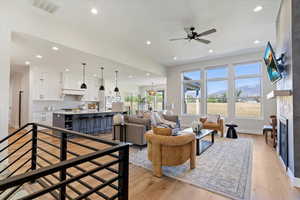 Living area featuring recessed lighting, light wood-style flooring, a fireplace, and ceiling fan