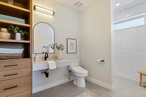 Bathroom featuring walk in shower and light tile patterned floors