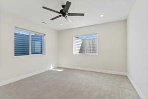 Unfurnished room with light colored carpet, recessed lighting, and a ceiling fan