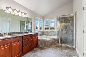 Ensuite Bathroom with double vanity and both a soaking tub and an enclosed shower