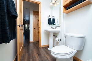 Bathroom with baseboards and dark wood-style flooring