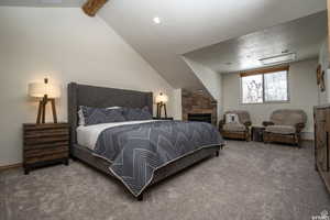 Carpeted bedroom with a textured ceiling and attic access