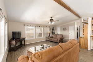 Living area featuring light wood-style floors and a ceiling fan
