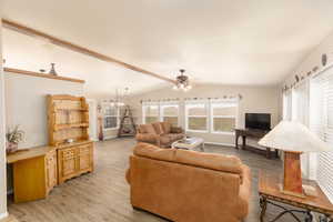 Living room featuring light wood-style floors and a ceiling fan