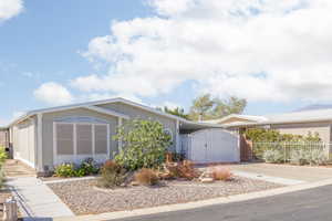 View of front of house featuring a gate and concrete driveway