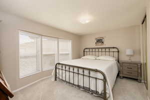 Carpeted bedroom with baseboards