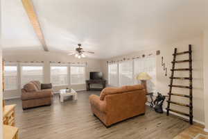 Living area featuring light wood finished floors and ceiling fan