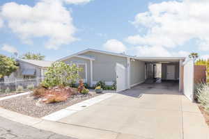 View of front of property featuring a carport and driveway