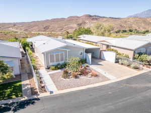 View of front facade with a carport, driveway, and a mountain view