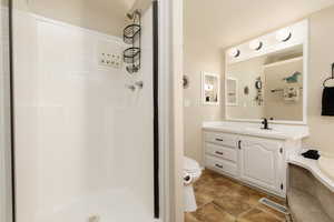 Full bathroom with vanity, a shower stall, a garden tub, and light tile patterned floors