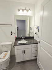 Half bath featuring vanity and light tile patterned floors