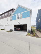 View of front of house with concrete driveway and a garage