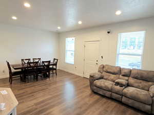 Living area featuring recessed lighting, wood finished floors, and a textured ceiling
