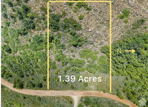 Aerial view of sparsely populated area featuring property parcel outlined