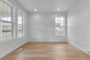 Spare room featuring light wood-style flooring and recessed lighting