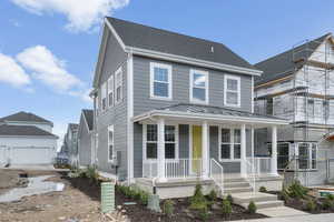 View of front of home with a standing seam roof, a porch, and a metal roof