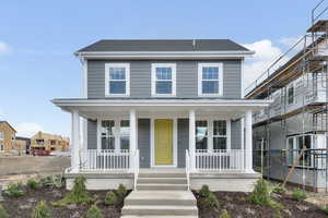 View of front facade featuring a porch and a shingled roof